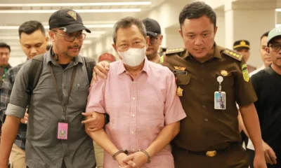 Tersangka kasus dugaan korupsi pengelolaan tata niaga komoditas timah di wilayah IUP PT Timah Tbk pada tahun 2015–2022, Hendry Lie (tengah), digiring oleh petugas saat ditangkap di Bandara Soekarno-Hatta, Tangerang, Banten, pada Senin (18/11/2024) malam. Kejaksaan Agung RI.